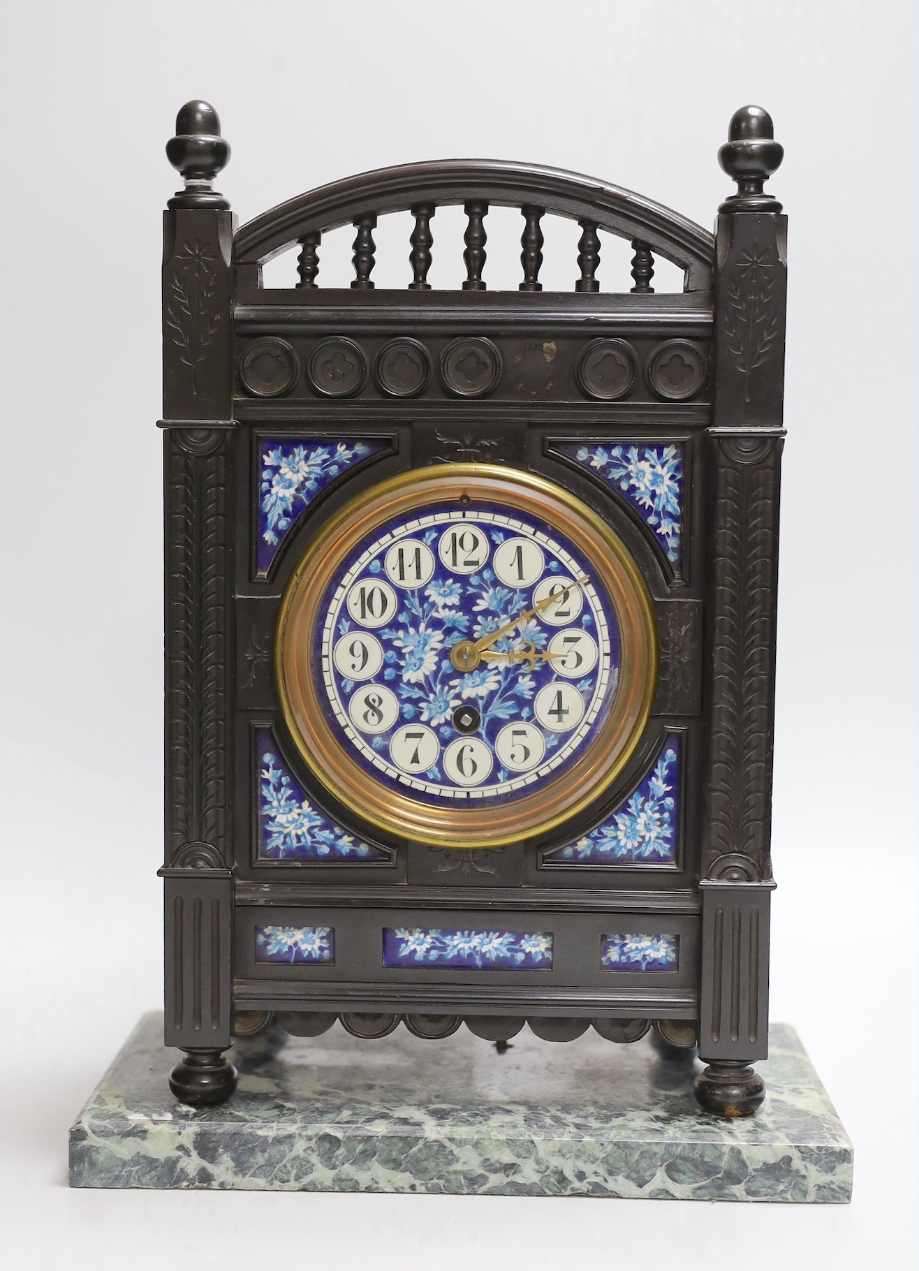 A Victorian Aesthetic Movement ebonised mantel clock in the manner of Walter Crane and Lewis Day. 32cm high